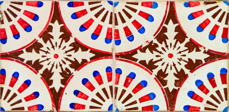Vibrant azulejos, painted with circular motifs in red, white, and blue, cover a building in Lisbon. These tiles reflect the artistic history and charm of Portugal's capital.の写真素材