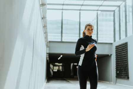 A determined runner practices in a sleek urban corridor, sunlight streaming through large glass...