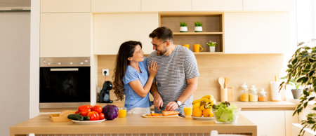 In a sunlit kitchen filled with fresh vegetables and fruits, a couple happily shares a playful...
