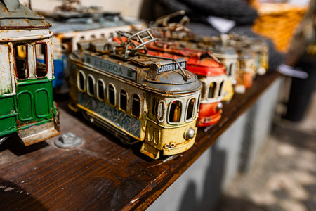 Lisbon, Portugal - February 17, 2025: Colorful model trams at a Lisbon market. Tram 28 is...
