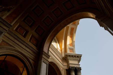 Visitors admire the stunning architecture of Galleria Vittorio Emanuele II while basking in the warm...
