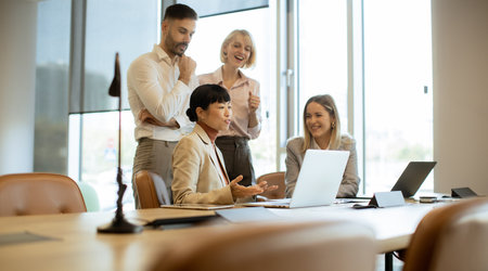 A diverse group of professionals engages in a meeting in a contemporary office setting. They discuss...