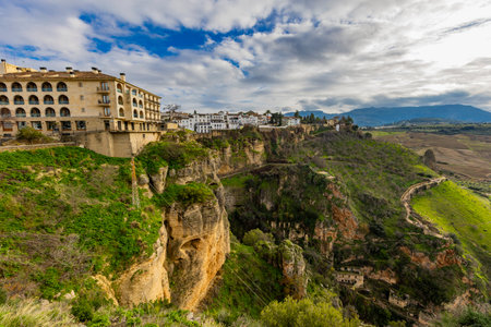 Perched on cliffs, Ronda showcases beautiful architecture, breathtaking landscapes, and rich heritage. Experience the charm of this historic town.の写真素材