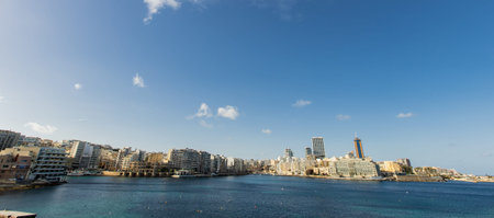 A scenic view from Independence Gardens reveals the stunning seafront of Sliema and St. Julians. The sun shines over Balluta Bay.の写真素材