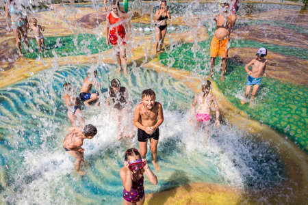 Happy children playing in a water fountain at the theme park Pattayaの写真素材