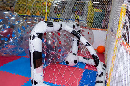boys in the children's center - playing football, sitting inside huge balloonsの写真素材