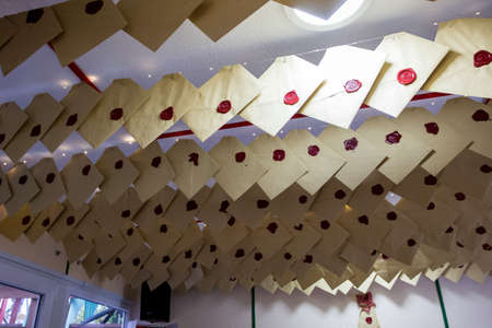sealed letters for Santa Claus hang from the ceiling, mail
