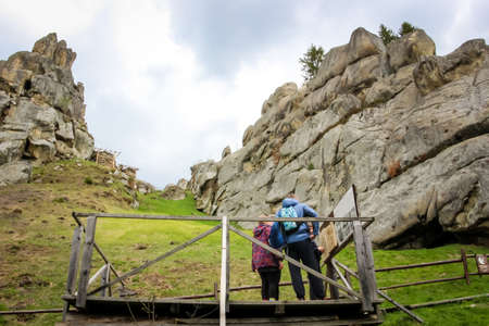 a young man with a girl on a stone rock fortress in the historical and cultural reserve, "Tustan", Carpathians, Western Ukraineの写真素材