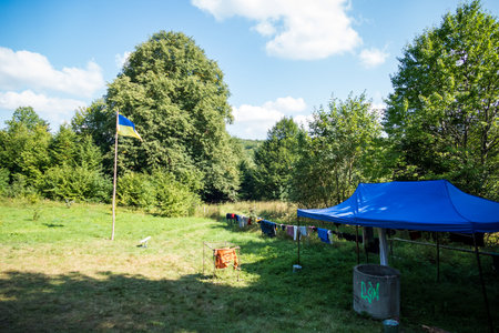 Ukrainian flag and fabric tents high in the mountainsの写真素材