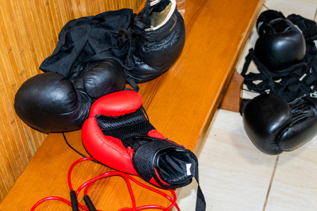 Boxing gloves and red boxing gloves on a wooden floor in a gym