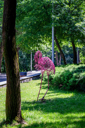 Pink flamingo sculpture in the park. Spring season, sunny day.の写真素材