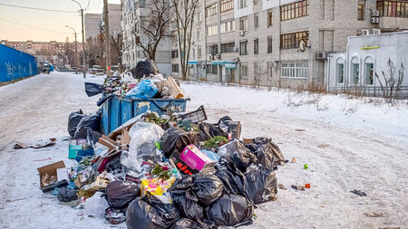 full garbage cans, mountains of garbage bags, old containers, cardboard boxes, thrown, on the...
