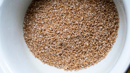 dry wheat groats from durum wheat in enameled dishes, most useful, contains vitamins, trace elements,  kitchenの写真素材