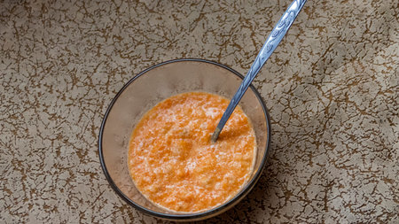 pumpkin orange porridge with spoon, vitamin mixture,orange marmalade, prepared by hand, at home, texture, color, ingredientsの写真素材