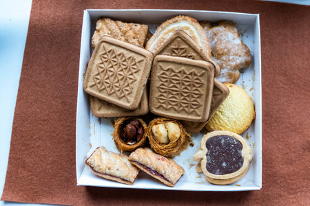 in box different types of cookies, square with patterns, gingerbread, round shortbread, with jam, sweets, bird's nests, nuts, hazelnuts, almonds, chocolate filling, glaze, white caの写真素材