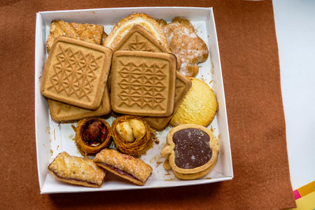 in box different types of cookies, square with patterns, gingerbread, round shortbread, with jam, sweets, bird's nestsの写真素材