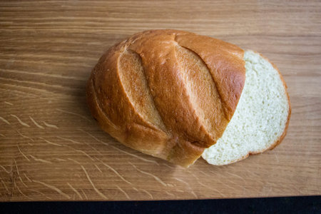 half of bread with cut slice on wooden surface, bun, bread roll, loaf, pastry, wheat flour, crispy...