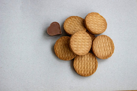 shortbread cookies and chocolate candy in  shape of  heart on  light background, a set of...