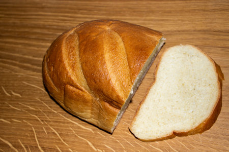 half of bread with cut slice on wooden surface, bun, bread roll, loaf, pastry, wheat flour, crispy...