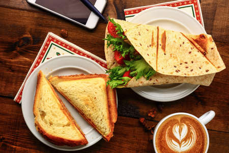 Breakfast with cappuccino and sandwich