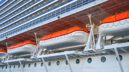Big life boats on a cruise liner deck of blue and white colored stripesのeditorial素材