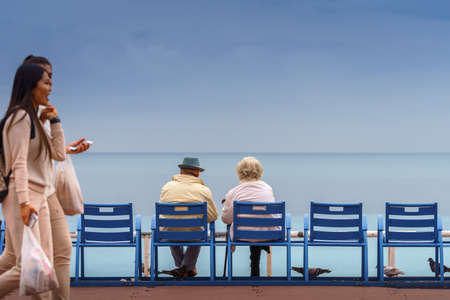 Old couple sitting on the bank of the sea. Happy and long life together.のeditorial素材