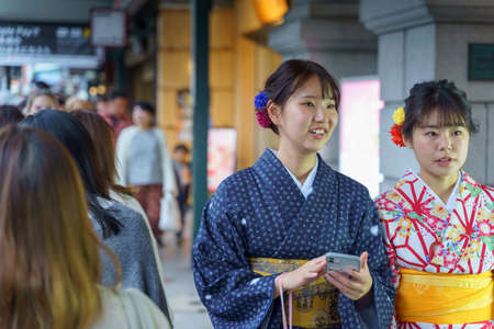 Japanese tourists and national costumes walk on the streets of Kyoto, Japan. Arashiyama is a popular tourist destination.のeditorial素材