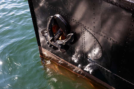 Anchor of the black ship on waterの写真素材