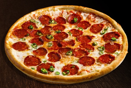 Pizza diavola with pepperoni and pimento - isolatedの写真素材