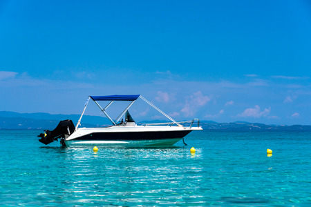 Stationary speed boats on  a calm sea, Mount Athos in the backgroundの写真素材