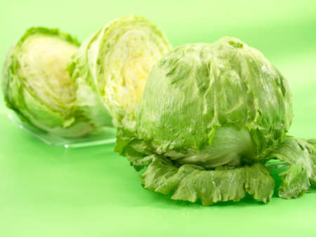 Fresh iceberg lettuces on green backgroundの写真素材