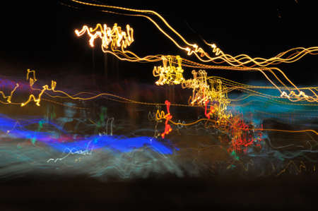 Background with glowing lines on the street by night 