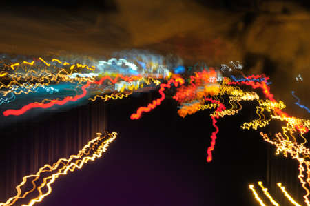 Background with glowing lines on the street by night の写真素材