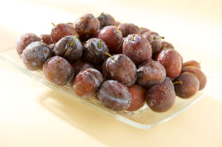Wet plum on plateの写真素材