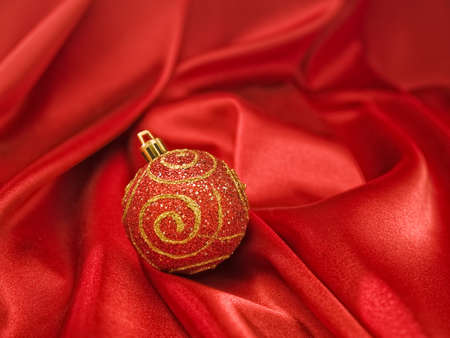 Beautiful red christmas ball on red fabricの写真素材