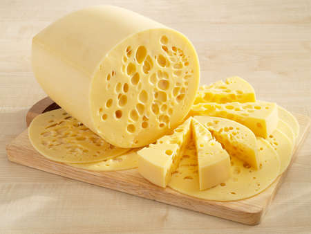 Beautiful yellow cheese on kitchen boardの写真素材