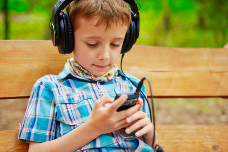 Young boy listening to music on stereo headphonesの写真素材