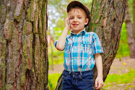 Young stylish boy talking on mobile phoneの写真素材
