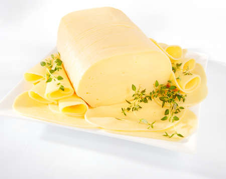 Fresh yellow gouda cheese on a plateの写真素材