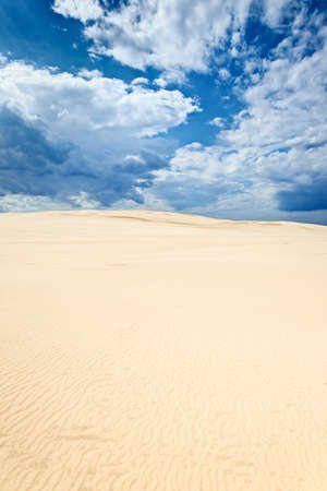 Sand dunes in the Slowinski National Park, Poland. Clouds blue sky desert background.の写真素材