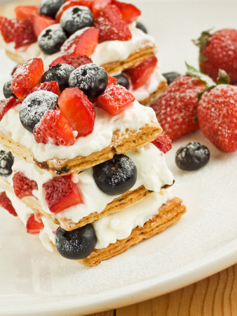 Strawberry-blueberry mille feuille with whipped sour cream. Shallow dof.の写真素材