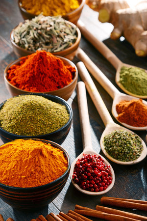 Variety of spices and herbs on kitchen table.の写真素材