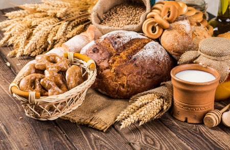 Assortment of baked bread on wooden table backgroundの写真素材