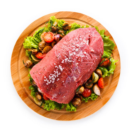Raw beef steak with mushrooms and vegetables. Isolated on a white background.の写真素材