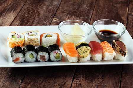 close up of sashimi sushi set with chopsticks and soy - sushi roll with salmon and sushi roll with smoked eel, selective focus.の写真素材