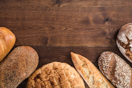 High Angle View Of A Variety Of Baked Bread On Wooden Table