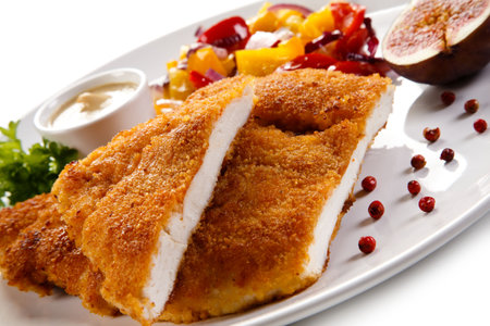 Fried Pork Cutlet with Vegetables and Sauce on White Backgroundの写真素材