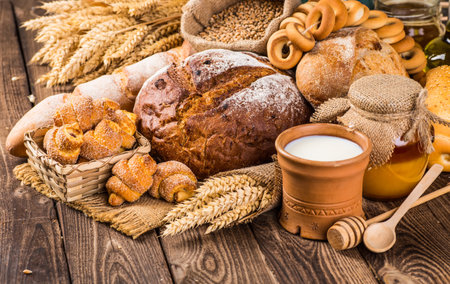 assortment of baked bread on wood tableの写真素材