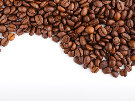 roasted coffee beans isolated in white background. Roasted coffee beans background close up. Coffee beans pile from top on white background with copy space for text. Good morning.の写真素材