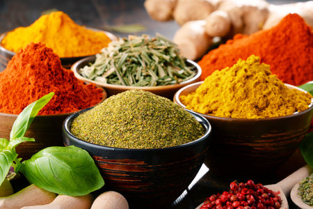 Variety of spices and herbs on kitchen table.の写真素材